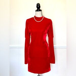 A red velvet mini dress with long sleeves.